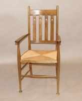 A late 19thC oak Arts & Crafts style open armchair