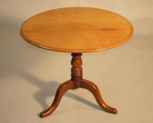 An early 19th century mahogany tripod tip top table