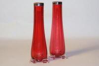 A pair of early 20th century cranberry glass bud vases