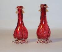 A pair of Victorian cranberry glass baluster vases