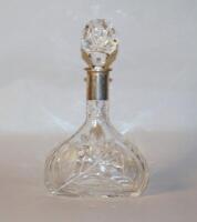 A cut glass and Continental silver decanter