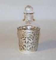 An Edwardian silver and glass Art Nouveau eau de cologne bottle