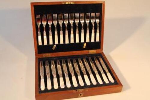 A set of twelve early 20thC dessert knives and forks