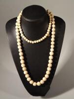 A bone beaded necklace.