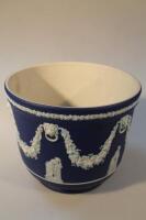 A Wedgwood Jasperware jardiniere decorated with swags and lion masks and classical figures