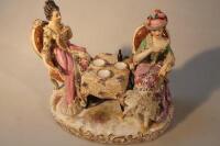 A 20thC porcelain figure group of two ladies seated by a table