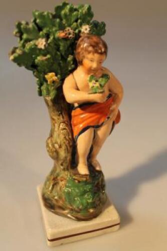 A 19thC creamware Staffordshire figure of a putti