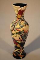 A Moorcroft slender baluster vase decorated with orchid pattern