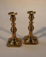 A pair of 19thC turned brass candlesticks