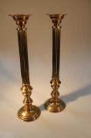 A pair of large brass pricket candlesticks