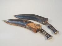 Two Kukri's in leather scabbards.