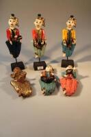 Six Indonesian carved wooden figures of drummers on plinths