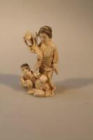 A Japanese Okimono figure group of a mother and two children fighting