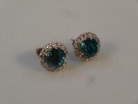 A pair of blue stone and diamond set cluster earrings