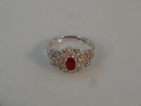 A large diamond and red stone 18ct white gold cluster ring