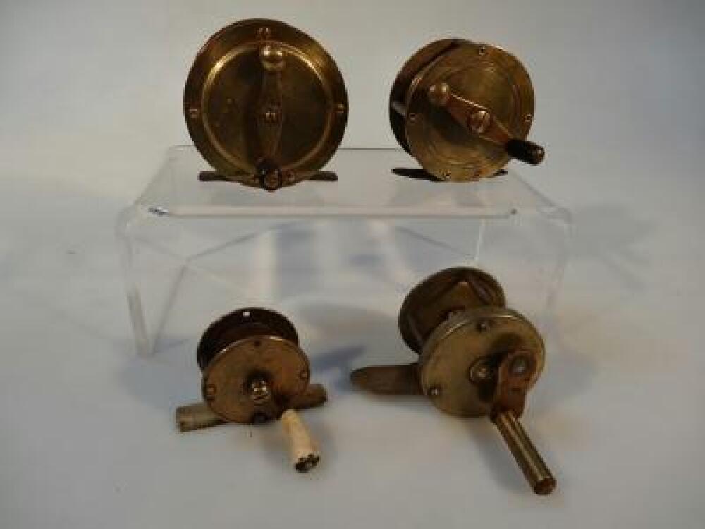 Five brass fishing reels including one by Milbro.