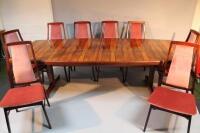 A large Heal's 1970's rosewood dining table and matching set of eight chairs