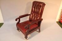 A late 19thC upholstered button back scroll armchair.