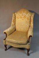 A 19thC wing back scroll armed armchair