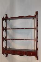 A 20thC mahogany four tier shelf rack