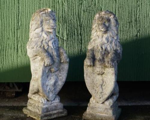 A pair of stone standing lion ornaments