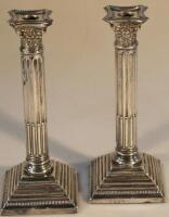 A pair of Edwardian silver candlesticks