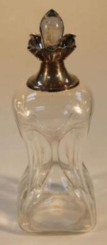 An early 20thC waisted glass decanter with silver collar