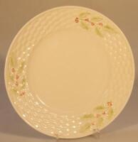 A Belleek plate decorated with holly