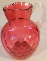 A Victorian cranberry glass jug