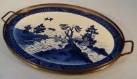 A blue and white willow pattern oval gallery tray