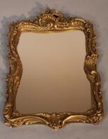 A gilt plaster Rococo style framed wall mirror