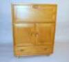 An Ercol light oak drinks cabinet