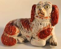A 19thC Staffordshire pottery figure of a recumbent spaniel