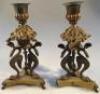 A pair of 19thC candlesticks with swan supports on trefoil bases