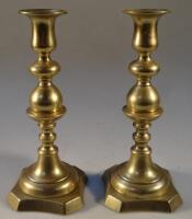 A pair of 19thC turned brass candlesticks