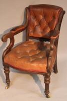 A 19thC button back scroll armchair