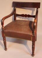 A 19thC scroll armed carver chair.