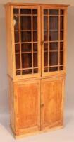 A 19thC stripped pine cabinet