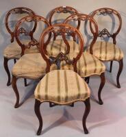 A set of six Victorian walnut balloon back chairs