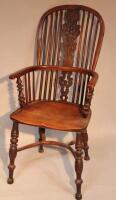 A 19thC yew and elm Windsor armchair of Nottinghamshire type with crinoline stretchers.