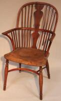 A 19thC yew and elm Windsor chair with turned legs and baluster stretchers.