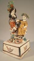 An early 19thC Staffordshire figure group of a musician and his female companion