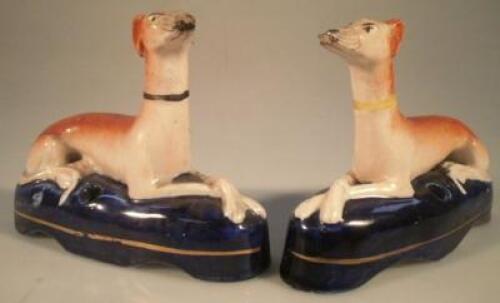 A pair of 19thC Staffordshire quill holders