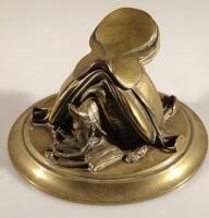 A 19thC cast brass inkwell in the form of a saddle