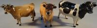 Three Beswick figures of cows