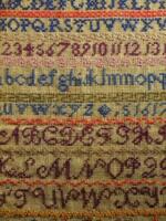 A 19thC sampler worked in coloured threads