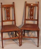 A pair of Arts & Crafts style oak dining chairs.