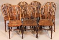 Seven wheel back kitchen chairs.