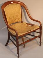 A late 19thC/early 20thC open armed upholstered salon chair.