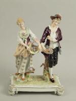 A 19thC Paris porcelain group of two figures carrying baskets of flowers